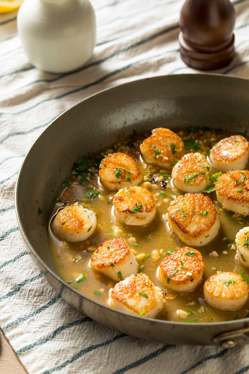 scallops with broth in a pan