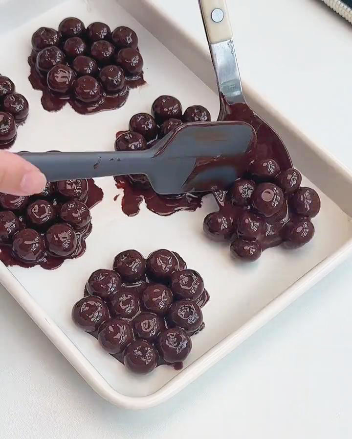arrange the blueberries in small clusters evenly on the baking tray