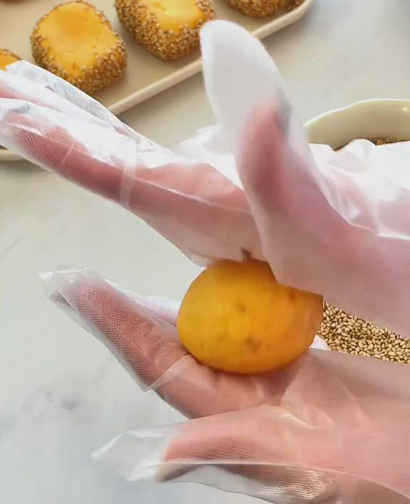 use both hands to gently roll the dough into a smooth round shape