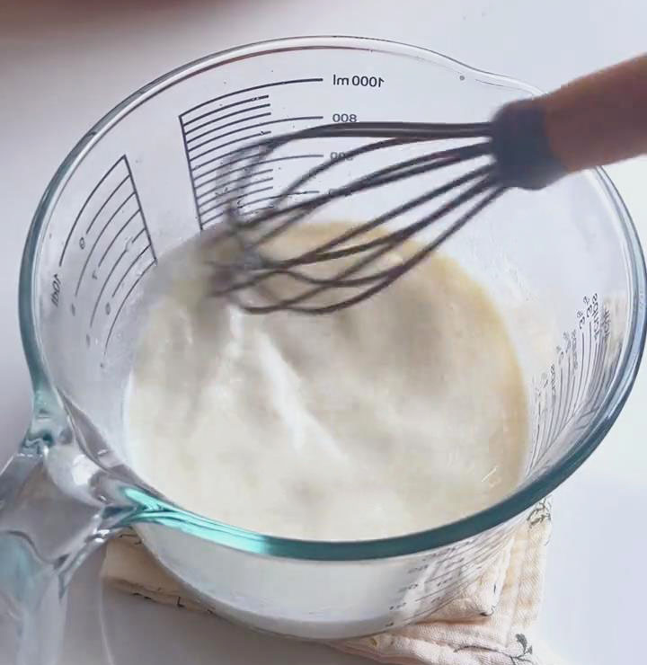 add 230g warm milk and stir with chopsticks add 230g warm milk and stir with chopsticks