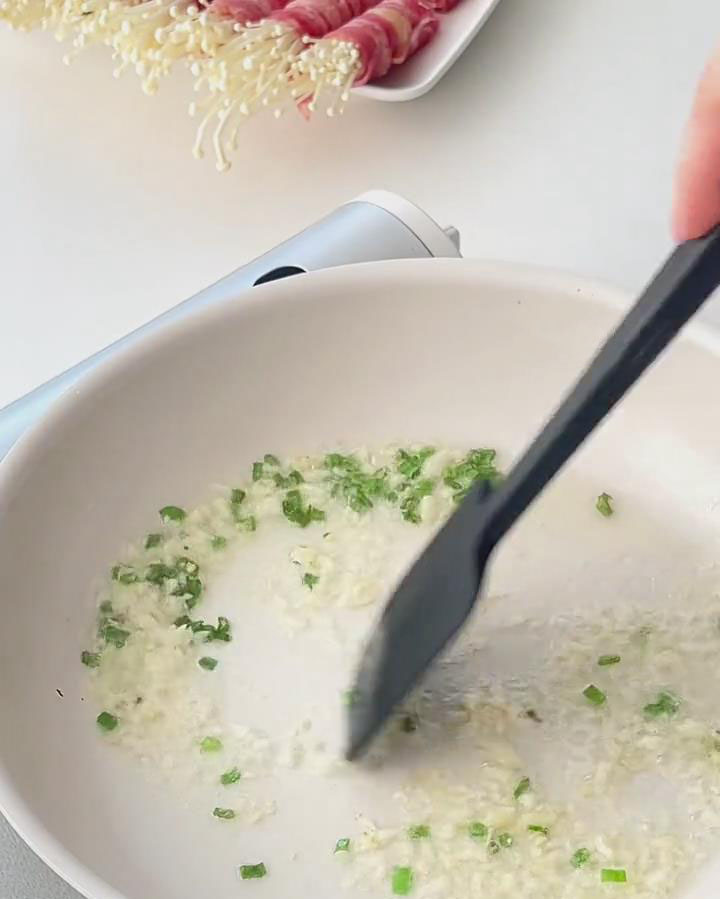 add the chopped spring onions and minced garlic