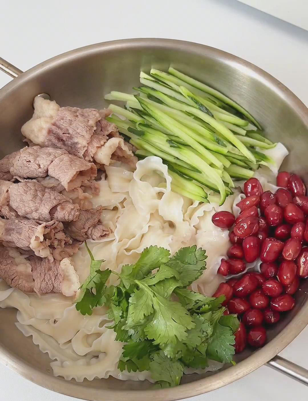 add the cooked beef cucumber fried peanuts and cilantro