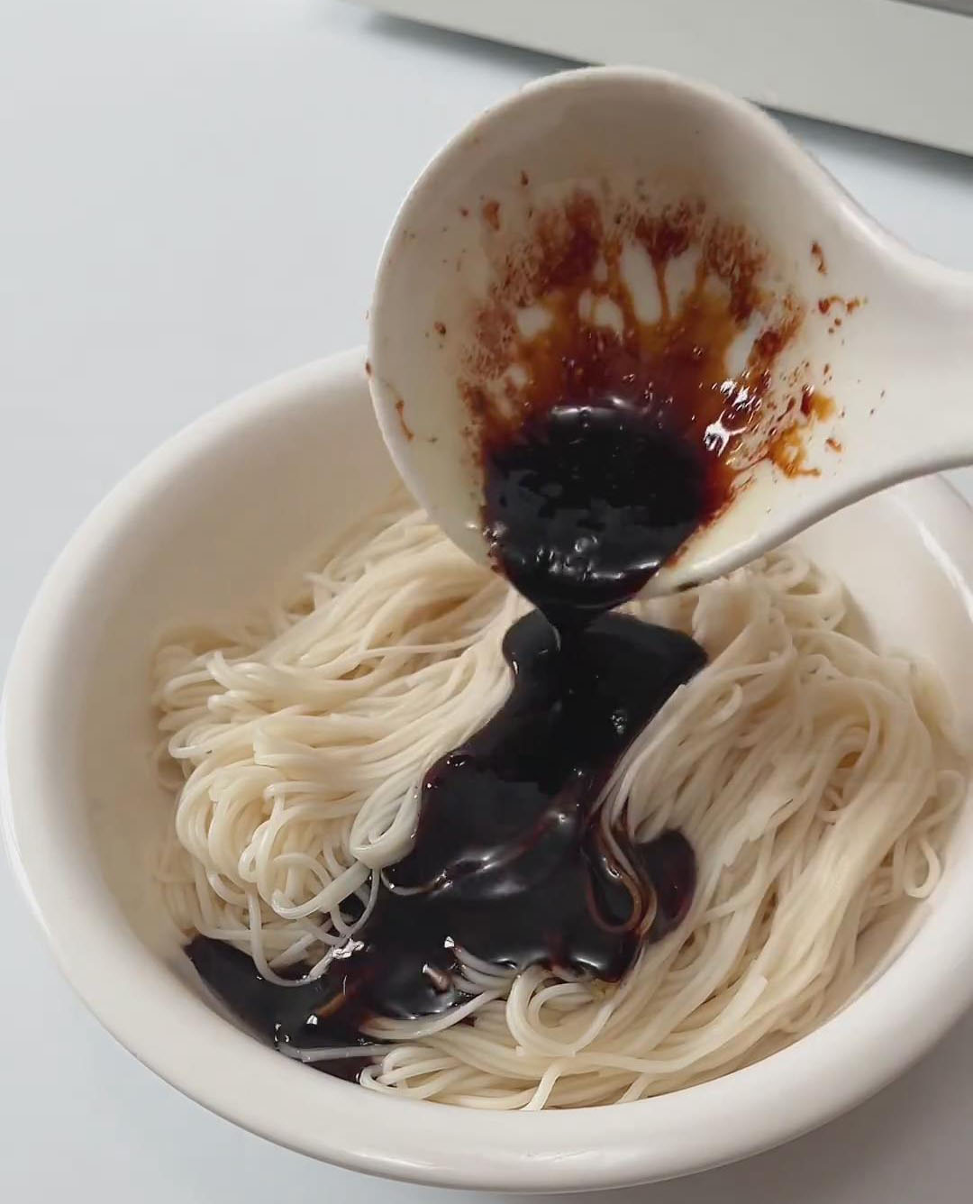 add the scallion sauce and toss the noodles until evenly coated