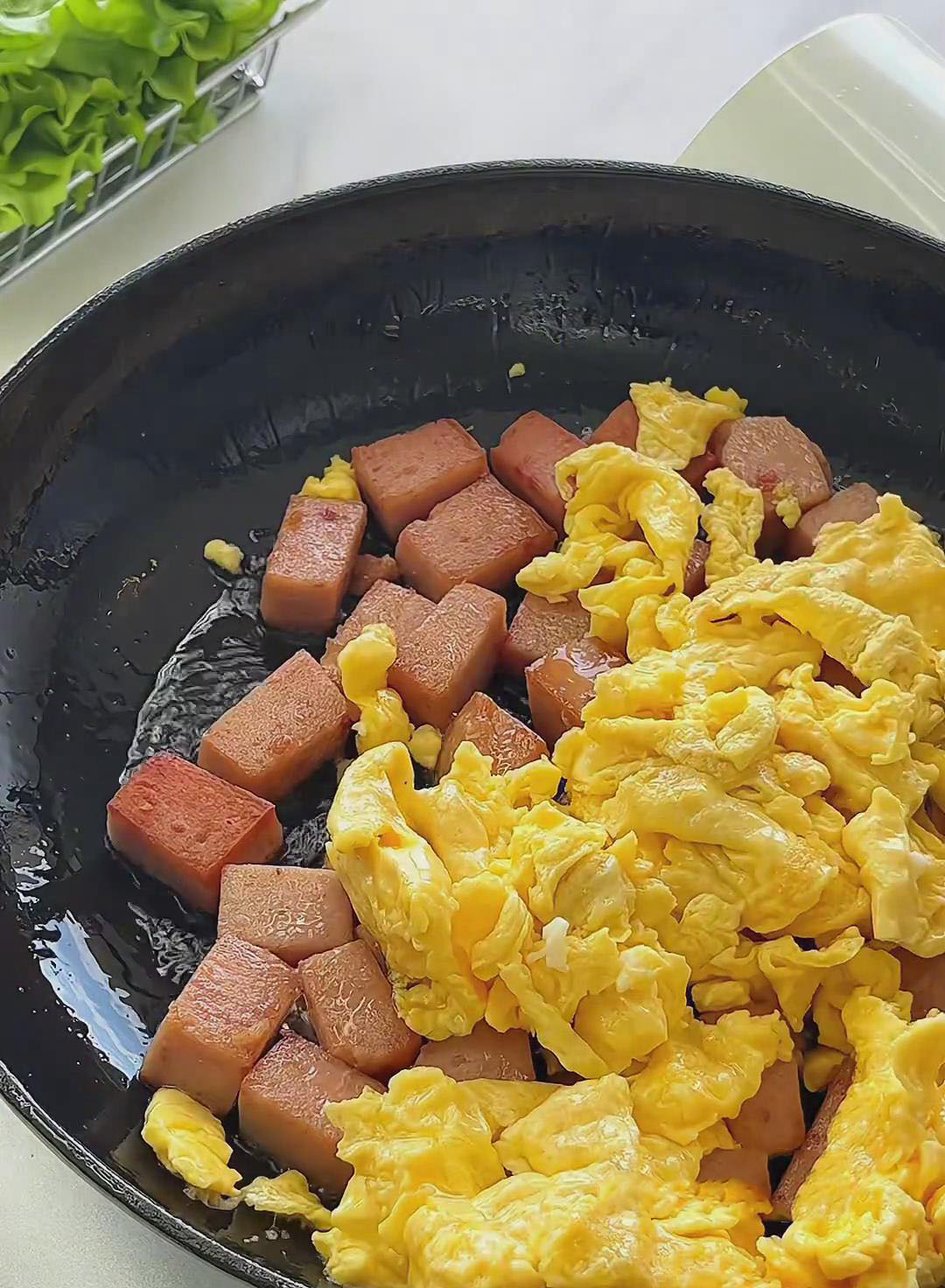 add the scrambled eggs back into the pan