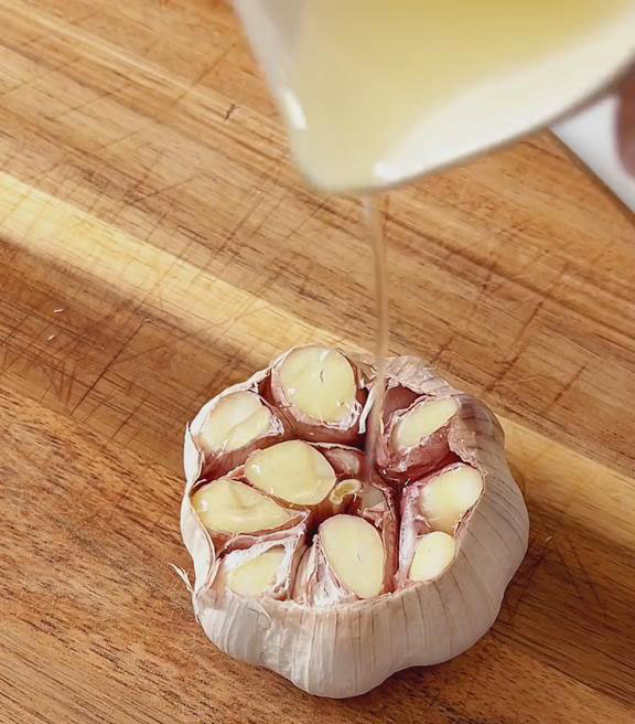 drizzle a little olive oil over the cut garli