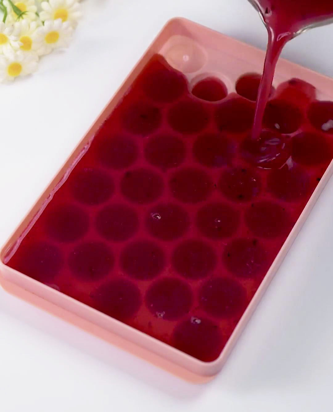 pour the fruit juice into ice ball molds pour the fruit juice into ice ball molds