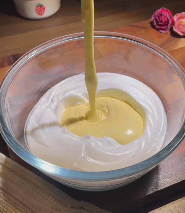 pour the yolk mixture into the remaining meringue