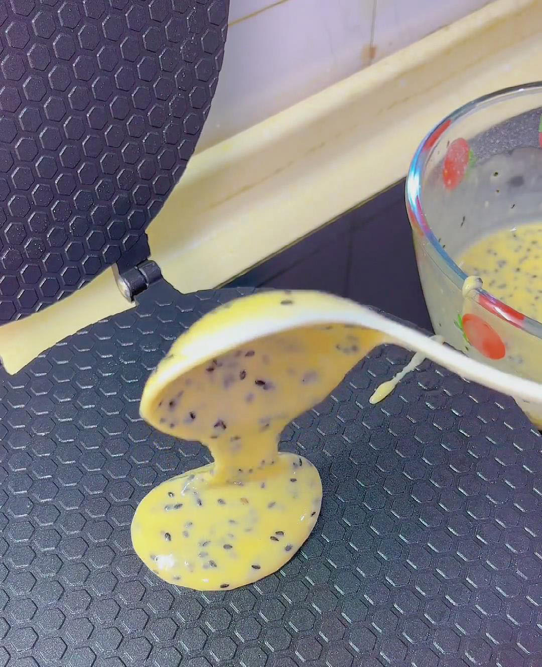scoop a spoonful of batter and pour it into the center of the preheated pan