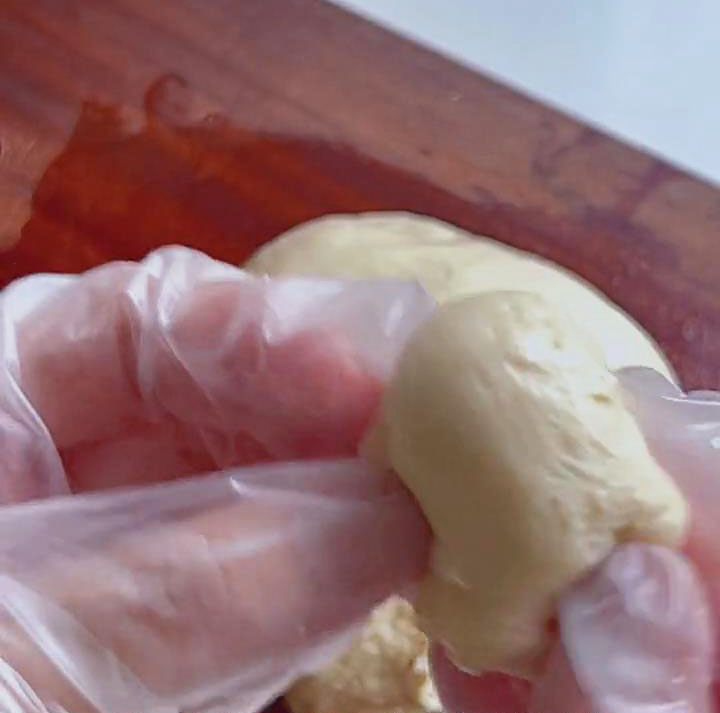 shape each piece into a small round ball by folding the edges inward shape each piece into a small round ball by folding the edges inward