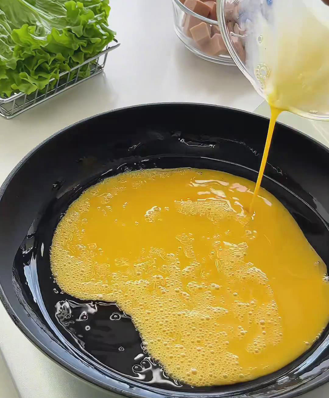 slowly pour in the beaten eggs