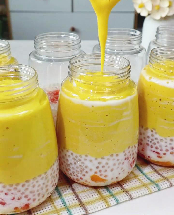 slowly pour the mango smoothie on top slowly pour the mango smoothie on top