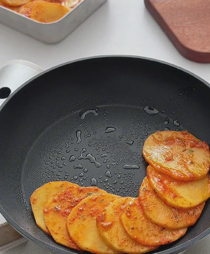 start layering the potato slices around the edge of the pan