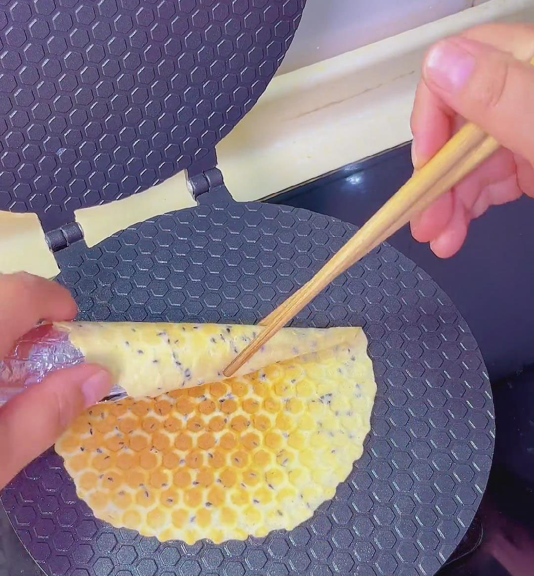 use chopsticks to guide and roll the pancake tightly around the mold
