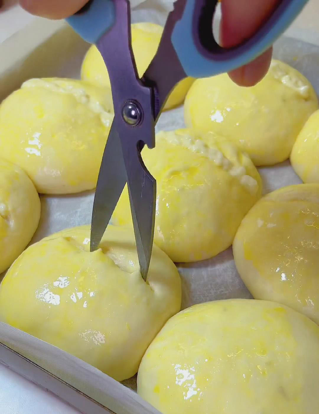 use scissors to make a small slit in the top of each roll