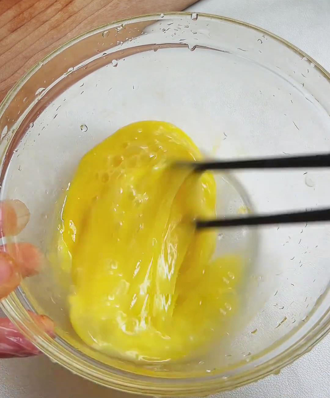 crack 2 eggs and beat them with chopsticks