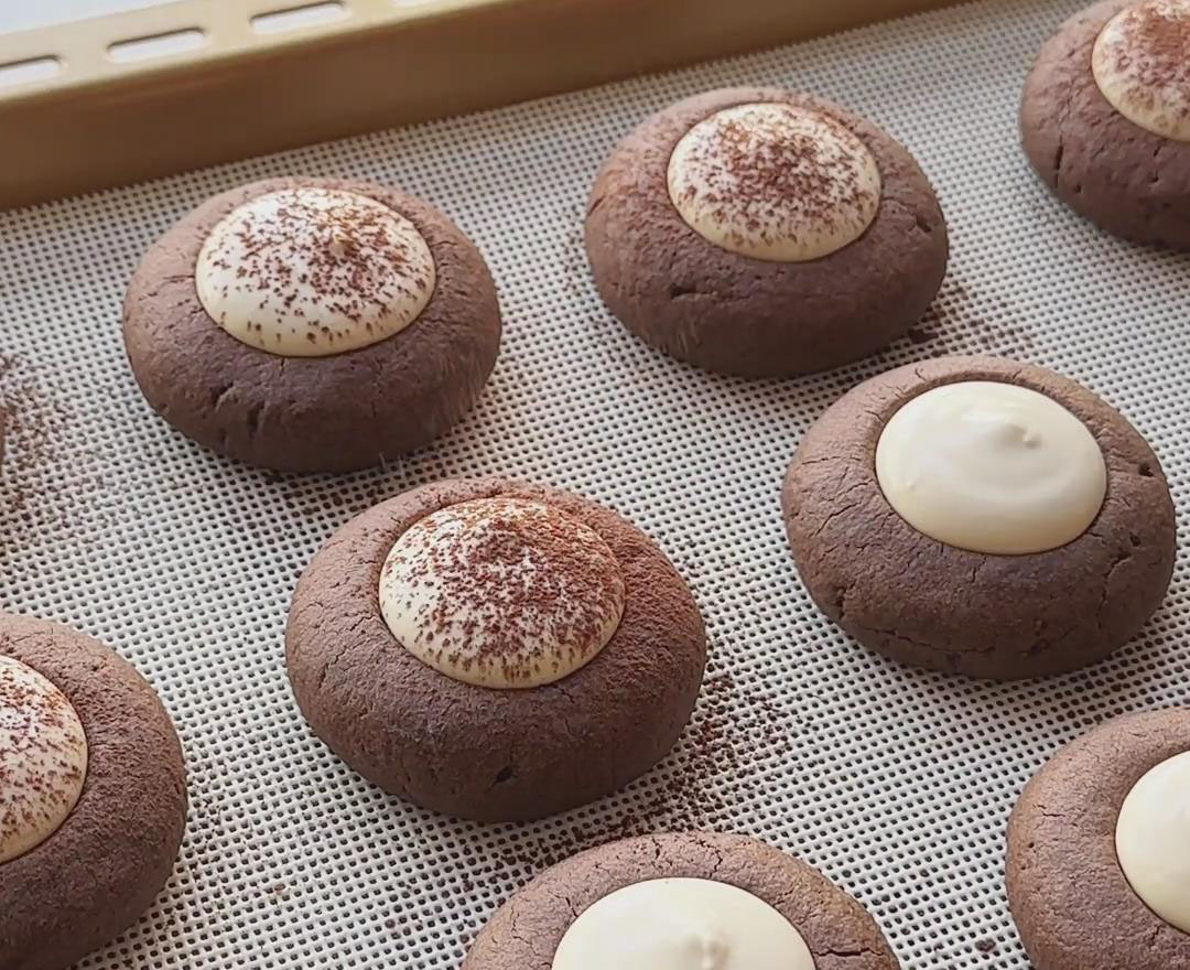 sift cocoa powder evenly over the tops of the filled cookies